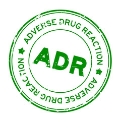 Grunge green ADR (Abbreviation of Adverse Drug Reaction) round rubber seal stamp on white background
