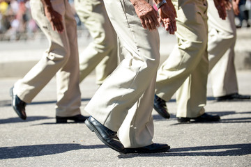 Military marching in a street. Legs and shoes in line