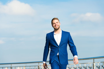 Success his second name. Businessman successful entrepreneur in suit walks outdoor sunny day sky...