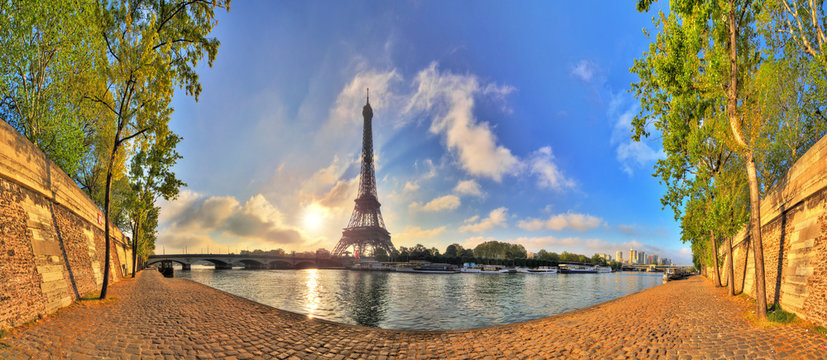 Beautiful 180 degree HDR panorama at sunrise in spring of the Eiffel tower at the river Seine in Paris, France