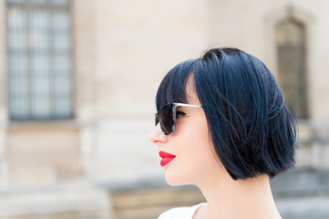 Girl fashionable lady with bob hairstyle outdoor urban architecture background. Woman fashionable...