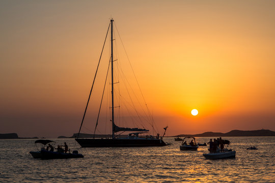 Sunset over sea with boats