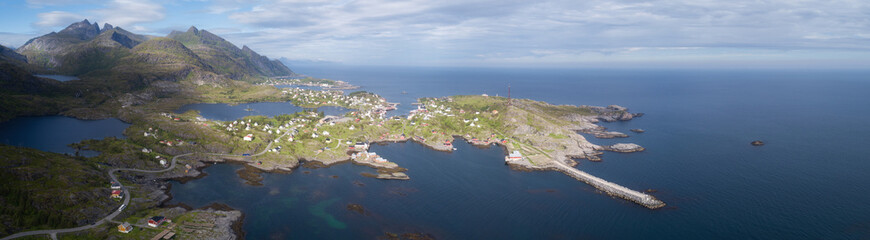 Beautiful aerial panorama of the blue sea surrounding the fishing village and rocky peaks Reine, Moskenes, Lofoten, Norway, sunny arctic summer