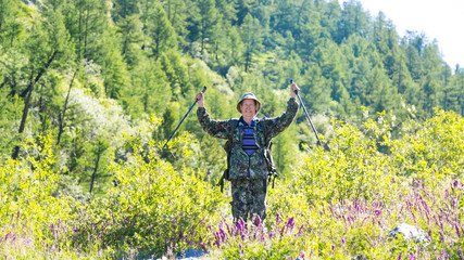 Tourist enjoys success. The man threw his arms up from the joy of victory.