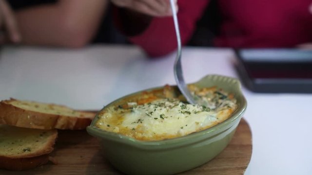 Fork eating baked spinach with melty cheese video 4k
