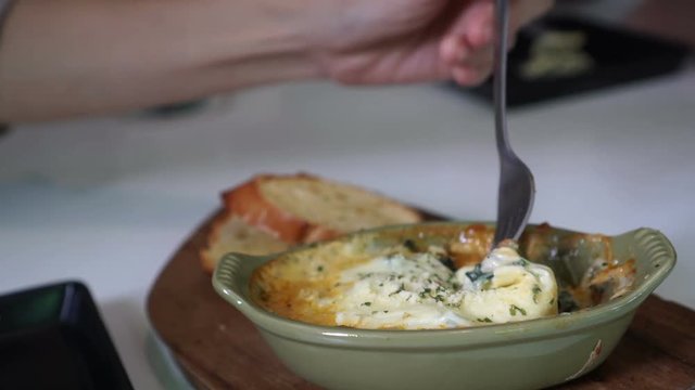 Fork eating baked spinach with melty cheese video 4k