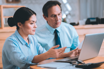 Something strange. Attentive female person actively gesticulating while discussing business plan