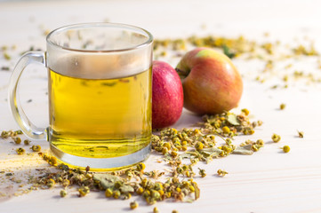 glass cup with fresh herbal tea with apples
