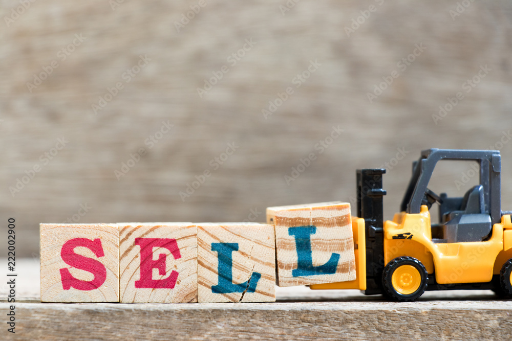 Canvas Prints Toy forklift hold letter block l in word sell on wood background