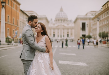 Young wedding couple by Saint Peter cathedral in Vatican