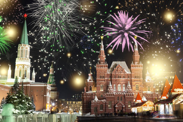 Festive salute and fireworks on the red square in Moscow. Salute lights over the Kremlin and GUM at the New Year celebration. Multicolored salute for Christmas in Moscow at night, Russia.