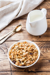 Healthy Breakfast baked muesli and milk on a wooden table.