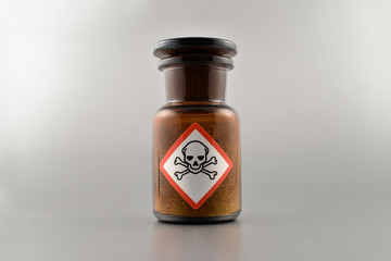 Vial with poison stock images. Vial with warning pictogram stock images. Laboratory accessories. Vials on a silver background. Brown glass containers. Brown chemical glass