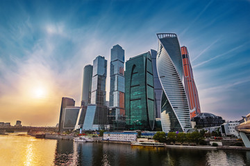 Fototapeta na wymiar Panorama of Moscow City - new modern International business center with futuristic architecture skyscrapers buildings reflected in Moscow river at sunset