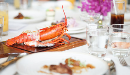 Lobster. Grilled lobster with juicy butter sauce served for the grand dining table.