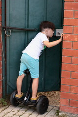 The brunette boy on the gyroscope left to open the door. - Who's come? Life in the village in the summer. Holiday.