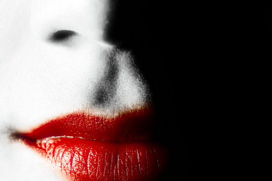 Red Lips Of A Young Woman On A Black Background