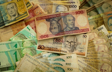 Fototapeta na wymiar Brasilian old money in paper of different years background. Brasil. Bills, notes.