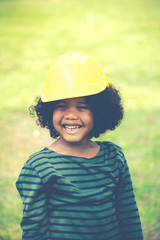 cute little African American boys  in a helmet, building and architectural concept