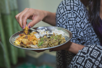 Nepali Hindu Woman having Dar or heavy Meal set on the Plate.Nepali Snacks Set.Khaja Set