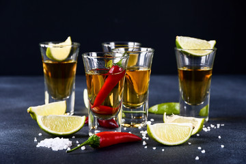 Red chili on a glass of alcohol, five glasses of alcohol and lime, a party at the bar, a menu for the bar. Selective focus and copy space