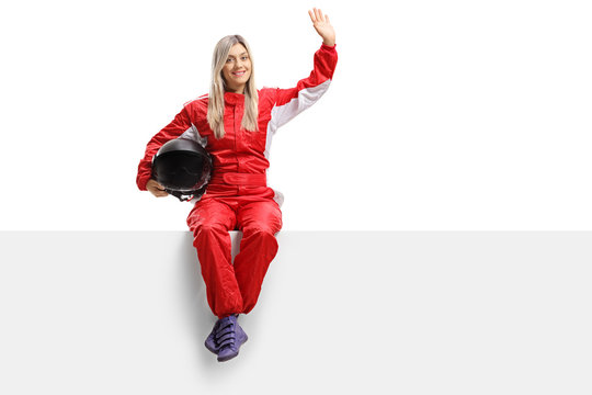 Female racer sitting on a panel and waving