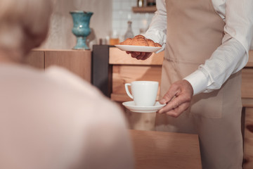 Delicious cappuccino. Cup of delicious cappuccino being served in the cafeteria to the customer