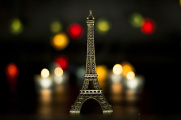 Eiffel tower on the background of colorful lights garland, bokeh.