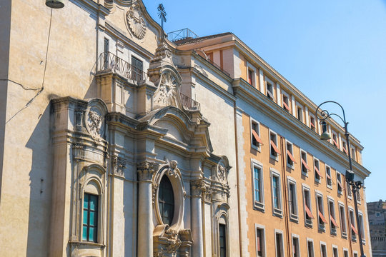 View on the ancient buildings and a historic church in Rome, Italy on a sunny day.
