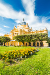     Zagreb, Croatia, art pavilion and beautiful flowers in park in summer day, colorful 19 century...