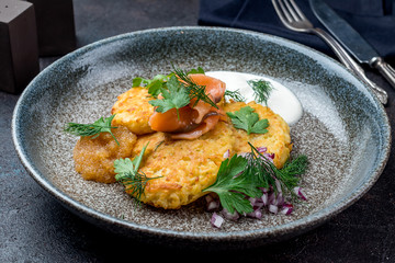 Fried potato pancakes with salmon