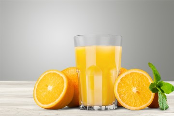 Orange juice and slices of orange on background