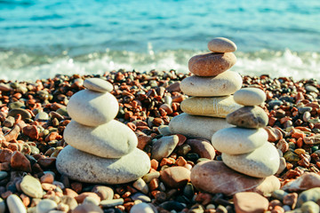 Fototapeta na wymiar balanced rocks at seaside. rocky beach on sunset.