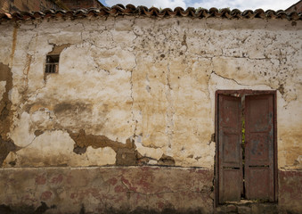 old wall with window and door