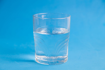 glass of water in color background