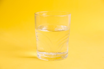 glass of water in color background