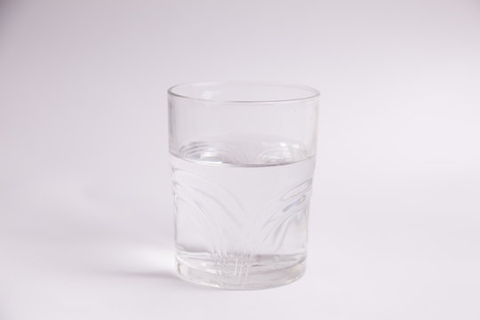 glass of water in color background