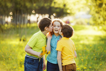 Obraz premium Little boys give his girl friend bouqet of yellow dandelions.
