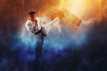  Karate man breaking with leg wooden board