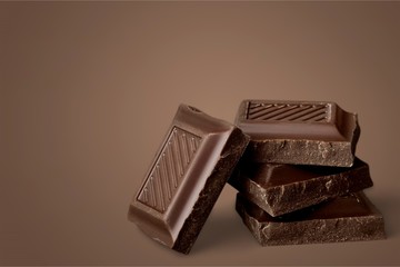 Delicious chocolates on background