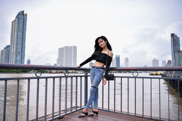 Business concept. A businesswoman is looking around for her holiday. Asian girls admire the view of the river.