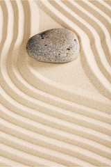 Fototapeta na wymiar Zen stone in the sand on Background