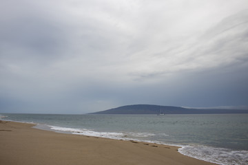 Fototapeta na wymiar Beach and Ocean with Gray Skies Tropical Storm Hurricane Maui Hawaii