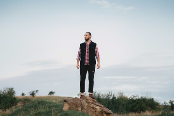 a man hipster walks in an autumn park