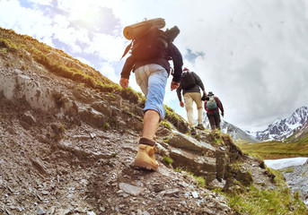 Group of tourists walking uphill by trek