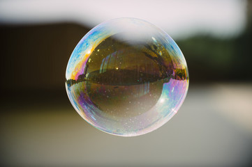 Soap bubble with the reflection of buildings inside.