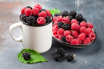 Cup of ripe blackberries and raspberries