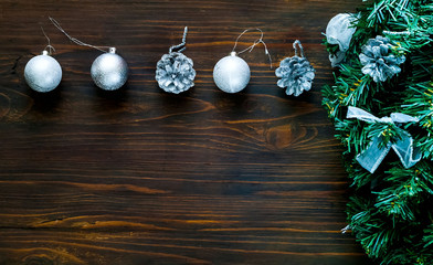 Christmas  decor. Decorative fir-tree with silver decoration and  silver balls on wooden background, concept of New Years holiday,closeup, copy space