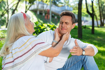 Obraz premium Already enough. Careful blonde woman going to kiss her son, sitting in semi position