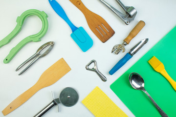 Background of kitchen utensils on white wooden kitchen table. tools. Top view.